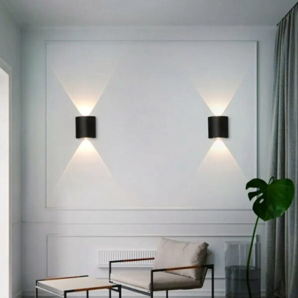 in a living room with light-colored walls, two classic black led wall sconces are shown