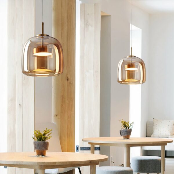 Smoked-glass LED pendant with modern design in a dining room above a table in front of a mirror