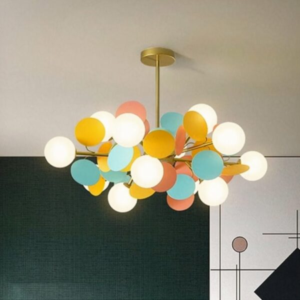 Minimalist, colorful children's chandelier with globes in a room with a dark green wall