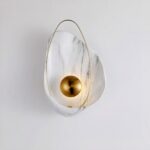 A white, marbled and gilded shell-shaped mural is set against a white background.