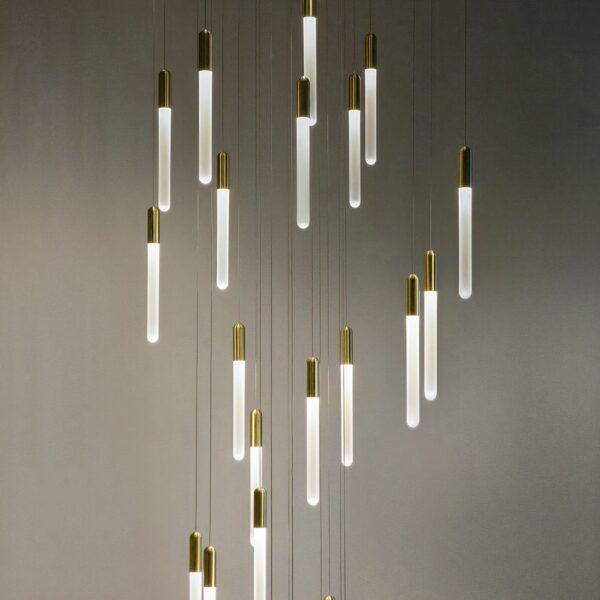 Nordic-design gold suspension with twenty-five heads on a grey background