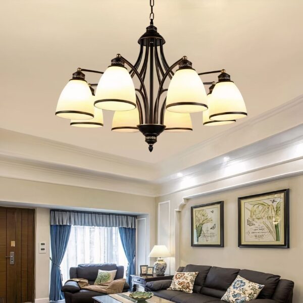 a bronze chandelier with glass shades can be seen in a living room