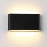 Rectangular black wall light, glued to the wall, with a light source at the top and bottom, lit. On a white wall.