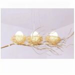 on a gray background, a bird's nest suspension with three eggs