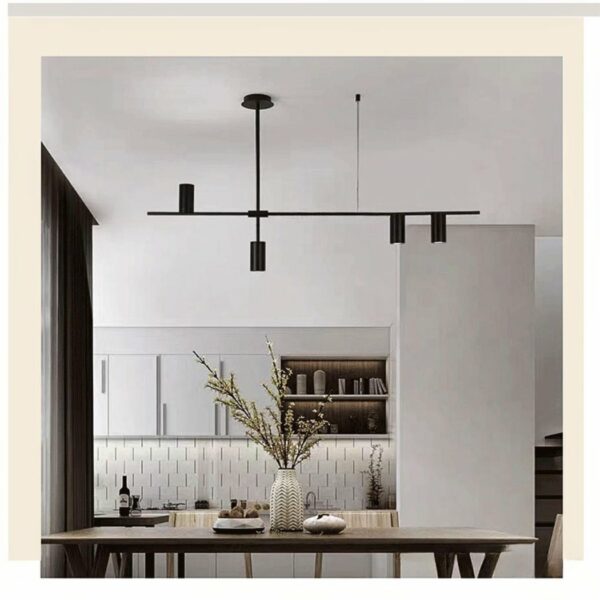 a white and grey living room with a white sofa and a black hanging lamp above a wooden coffee table in the minimalist style