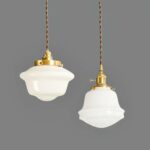Rustic, ceramic-style white glass pendant in two versions, suspended from the ceiling on a dark gray background.