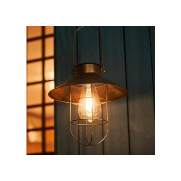 Copper lantern pendant light with a wire cage glowing warmly at dusk