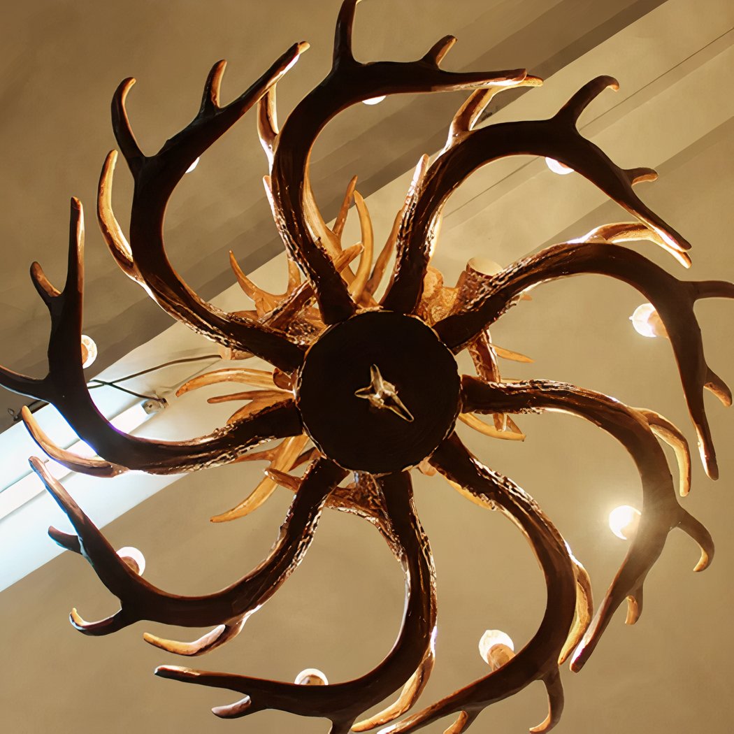 Overhead view of a dark antler shaped chandelier with radiating branches and lights