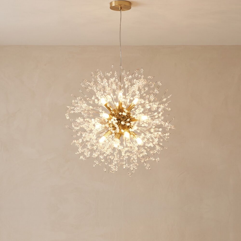 Gold dandelion chandelier, 60 cm in diameter, lit against a beige wall