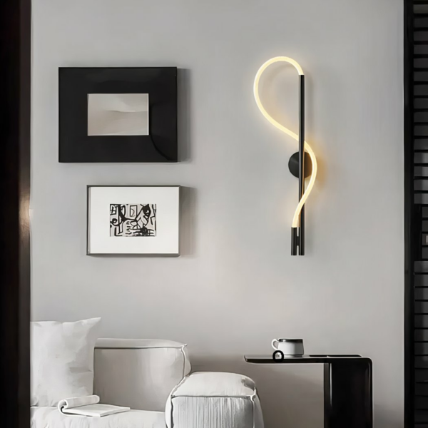 S-shaped black LED industrial wall light in a saline with two black and white frames on the left side