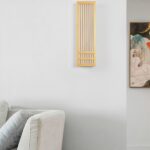 Japanese style wood wall light with a slatted pattern, shown unlit beside a sofa