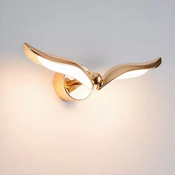 On a white background, a golden bird-shaped wall application is lit up.