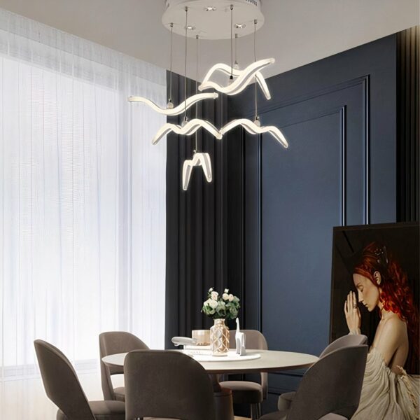 Nordic-design LED bird hanging lamp presented above a dining table