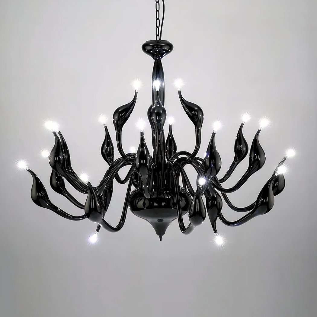 Black sculptural chandelier with curling wave shaped arms and small bulbs