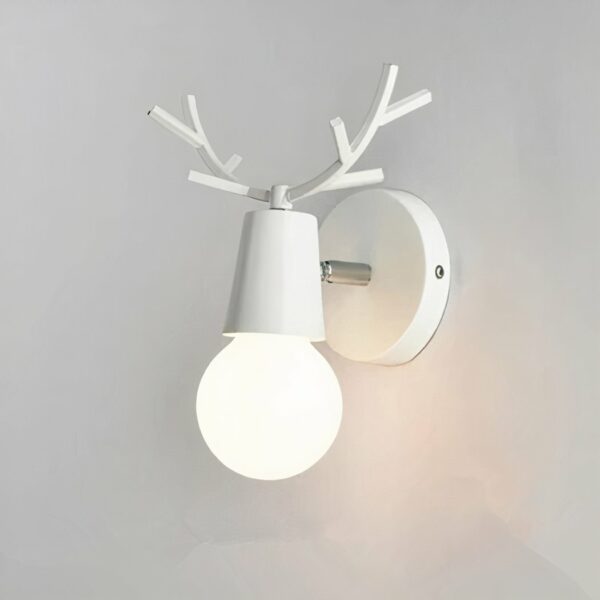 Minimalist stag's head wall light, white. With one light bulb. Hanging on a light gray wall.