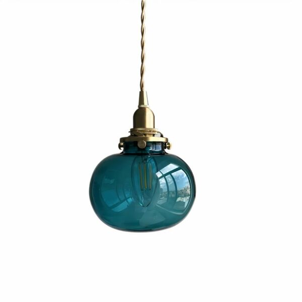 Hanging lamp with gold cable and gold lampholder with duck-blue glass ball.