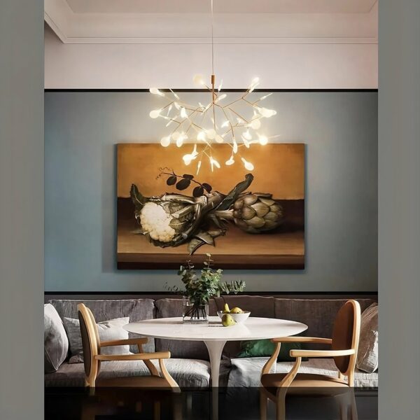 Original modern gold tree-shaped LED pendant chandelier suspended and lit above a dining table.