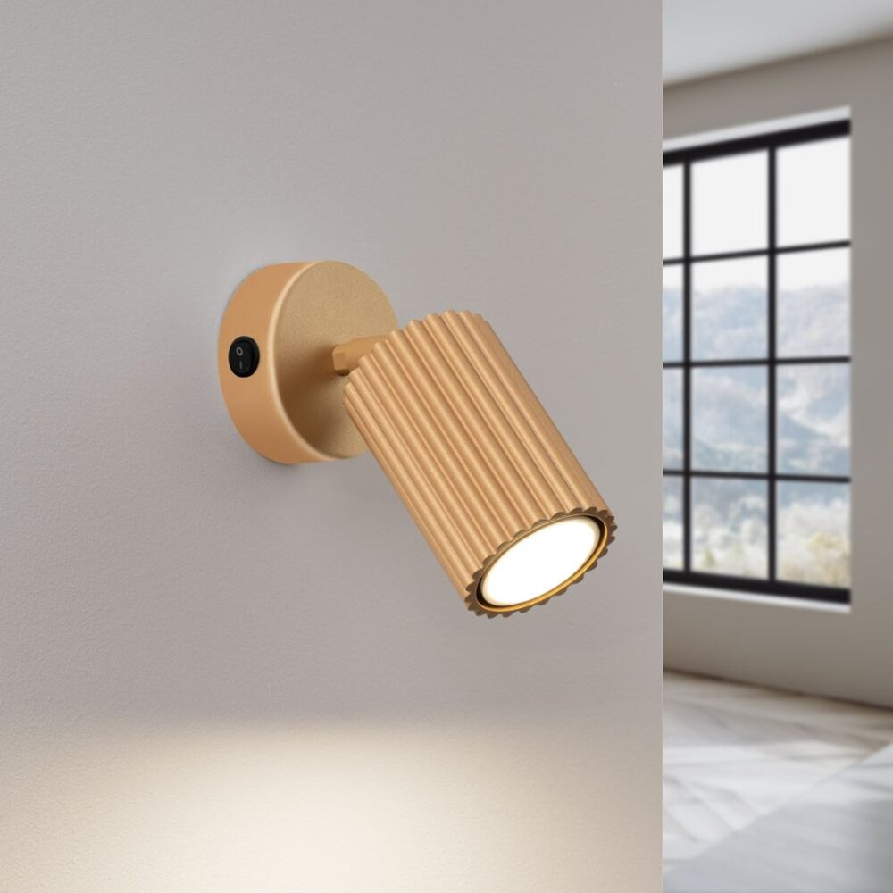 Gold adjustable reading wall light with ribbed texture and switch