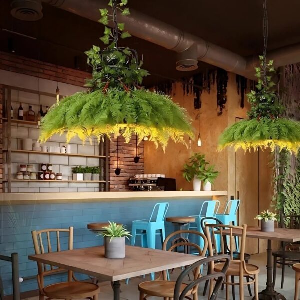 Round jungle foliage pendant lights hanging above a restaurant seating area