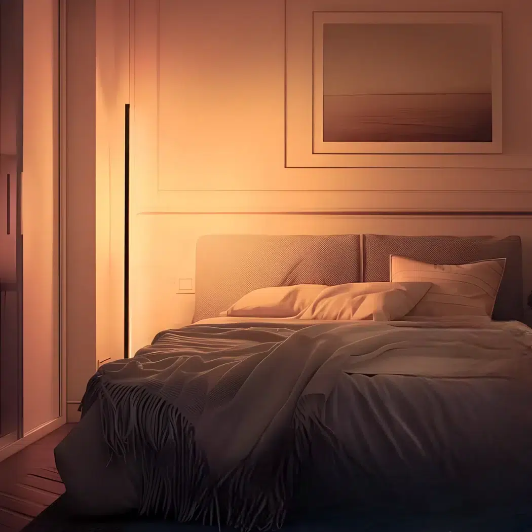 Warm white corner floor lamp glowing beside the bed in a cosy bedroom