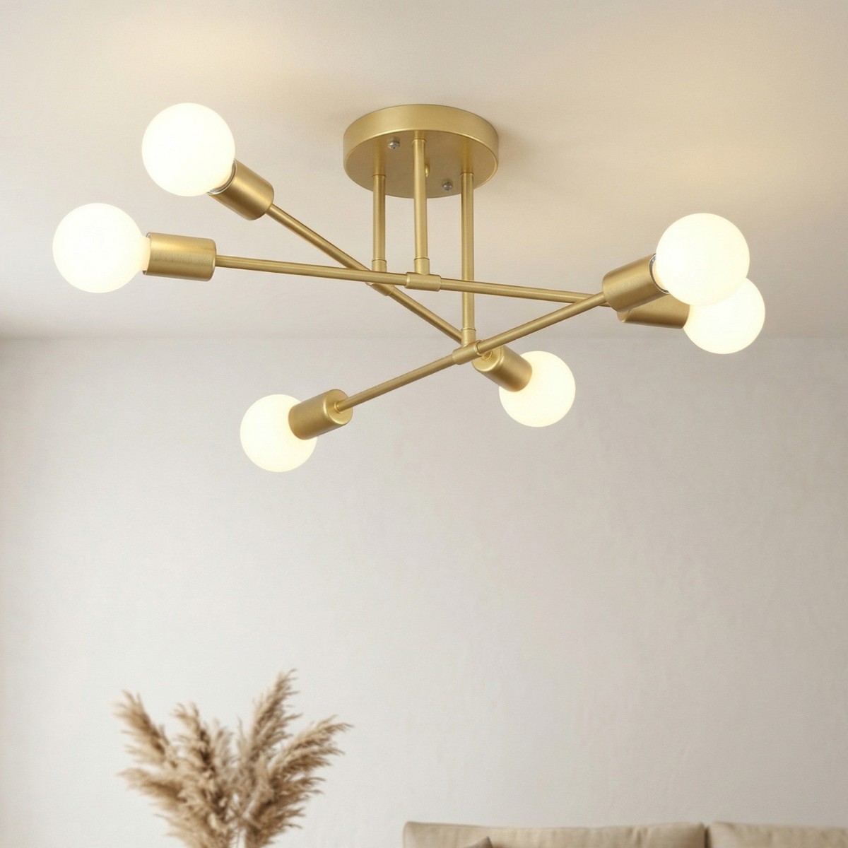 Flush ceiling light with six angled arms and round opal glass globes in brushed brass
