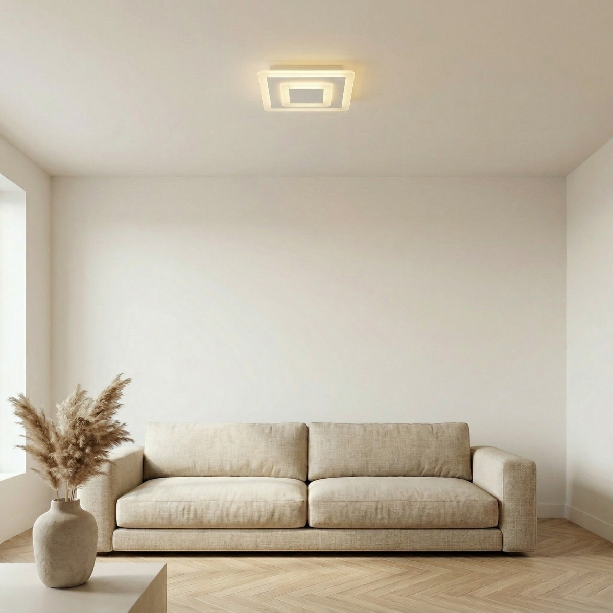 Square layered-pattern LED ceiling light above a beige sofa