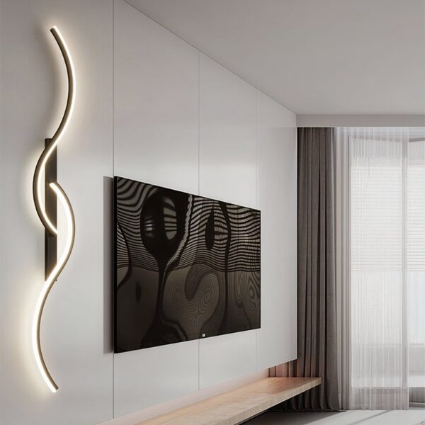 Black wavy S-shaped LED wall light beside a mounted television