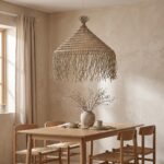 Braided rope chandelier hanging above a wooden dining table
