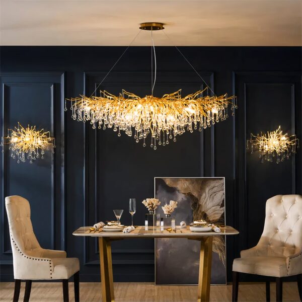 Gold branch-like chandelier draped with crystal droplets over a dining table