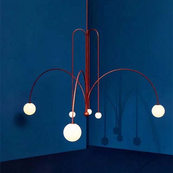 Terracotta curved branch chandelier with white glass globes against a blue wall