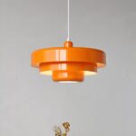 Orange tiered metal pendant light with a glossy lacquered finish