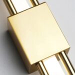 Close-up of the black square bracket joining two gold vertical light bars