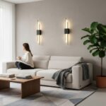 Two vertical linear LED wall lamps flanking a sofa, both switched on