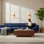 Two gold-toned vertical linear wall lamps lit above a navy blue sofa