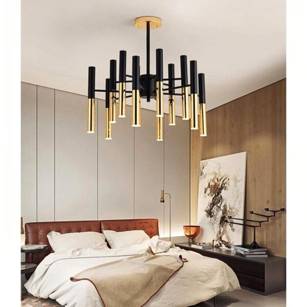 Black and gold multi arm chandelier with slender brass tube lights above a bed