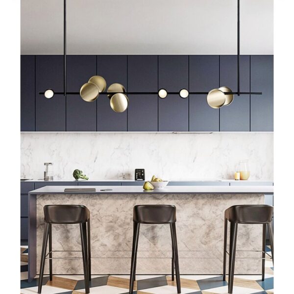 Black linear ceiling pendant with brass and white spheres over a kitchen island