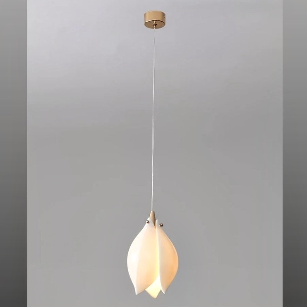 White magnolia-shaped ceramic pendant light on a long hanging cord