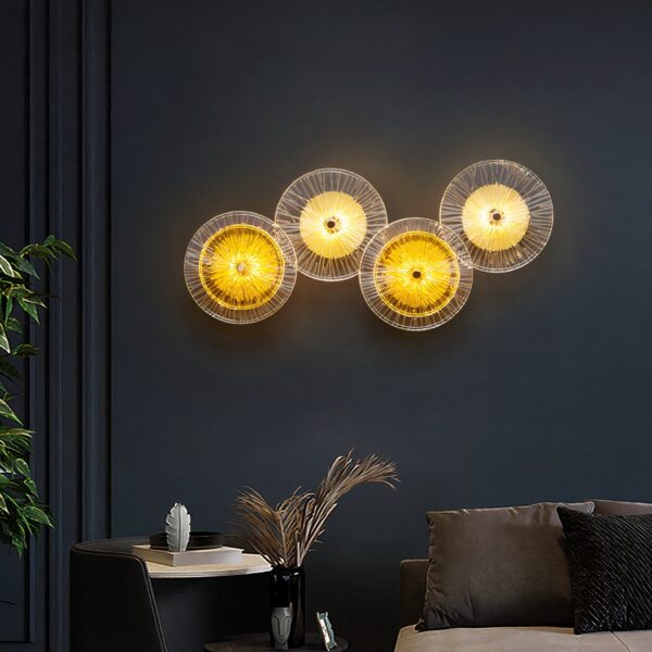 Wall light with four overlapping glass discs glowing yellow