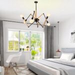 Multi-arm spider chandelier with wood and white arms in a bedroom by a window