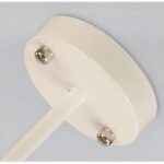 Close-up of the round ceiling canopy and knurled screw fittings on a cream cord