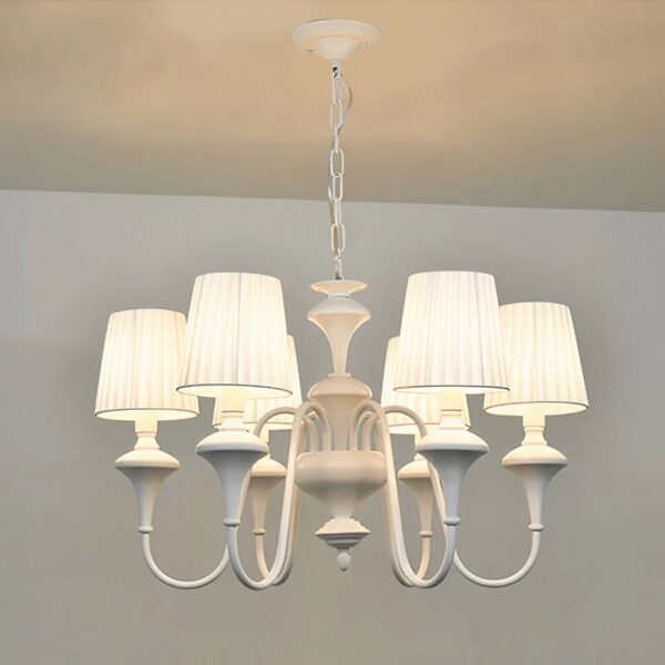 White chandelier with six pleated fabric shades on curved arms